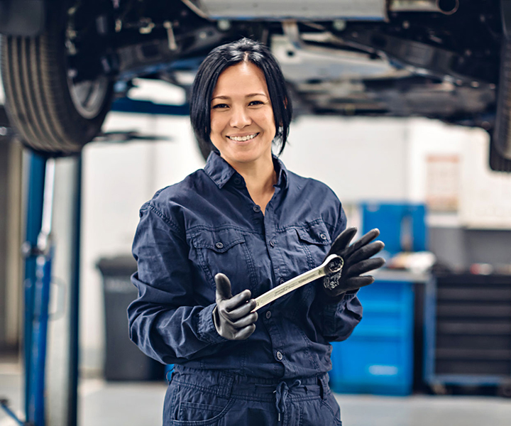 Woman holding wrench Woman holding wrench